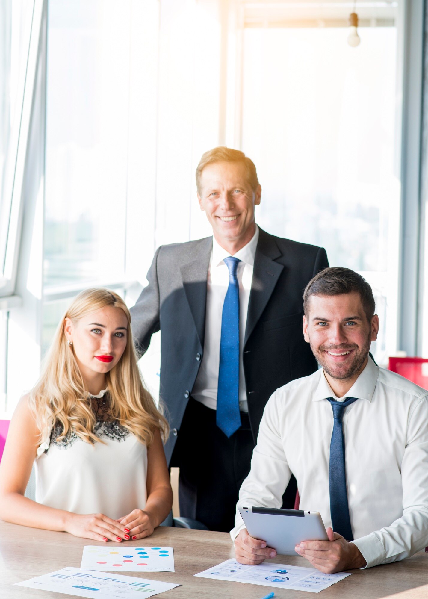 portrait-boss-with-his-two-colleagues-workplace-office_23-2147899935