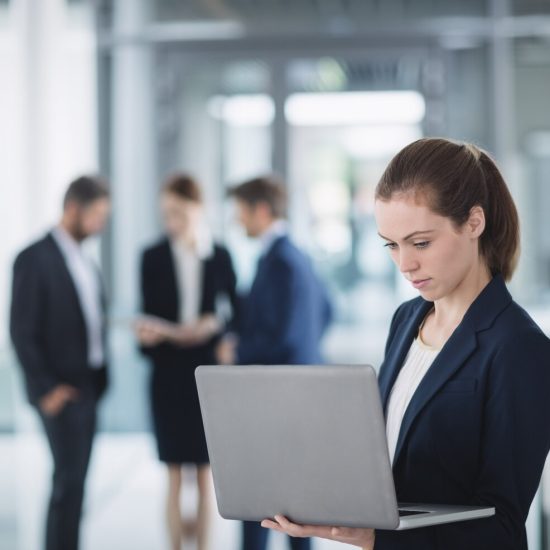 businesswoman-using-laptop_107420-84818
