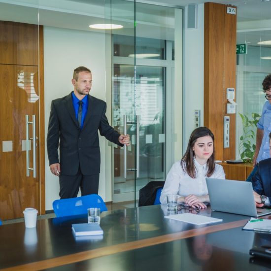 man-entering-room-with-coworkers_23-2147656726